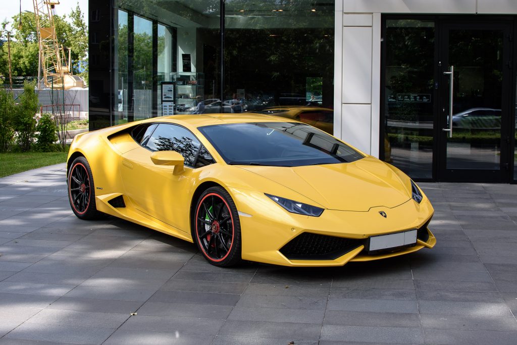 Lamborghini auto show next to a yellow Lamborghini.
